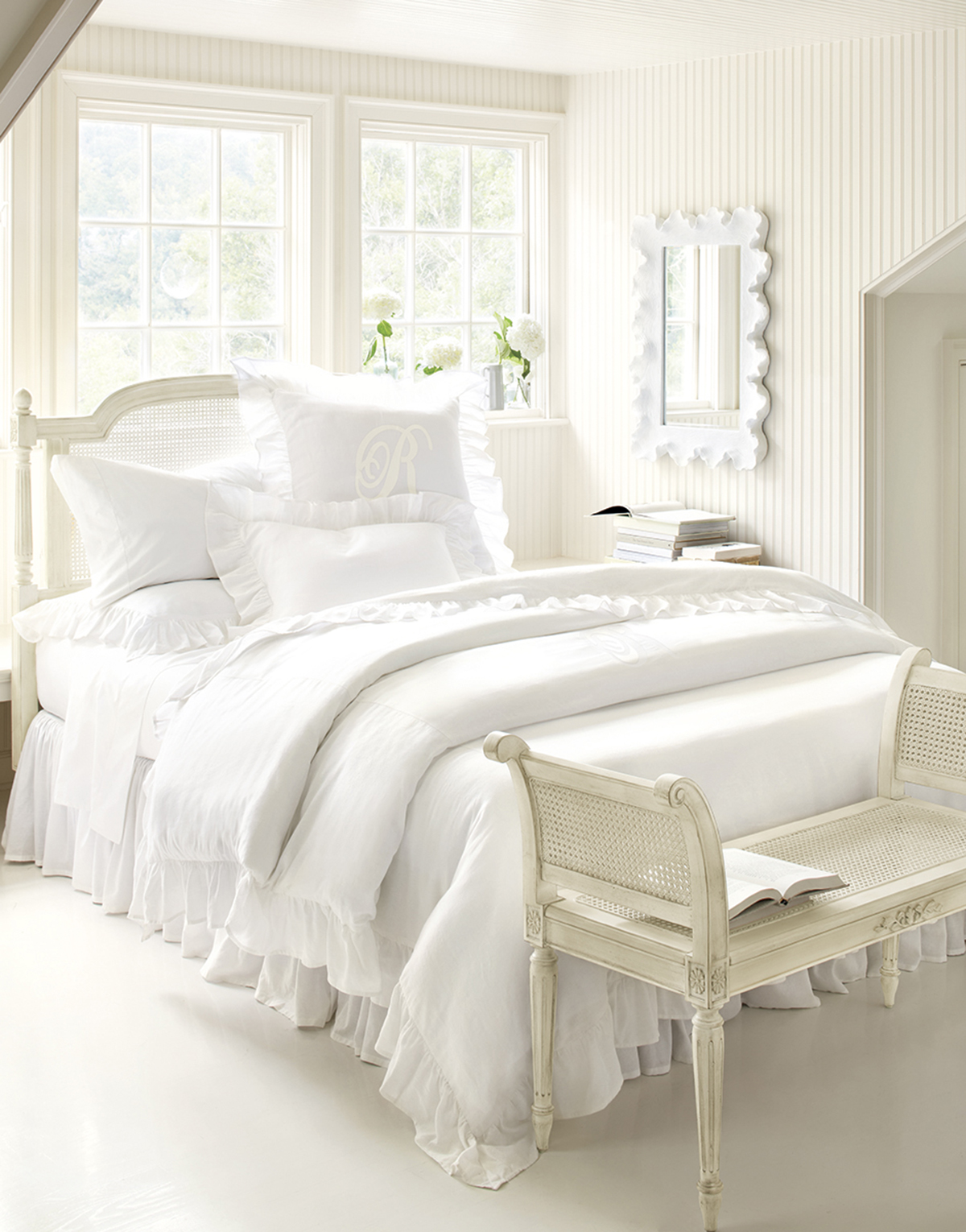 A White Bedroom With Patterned Wallpaper And A Striped Rug