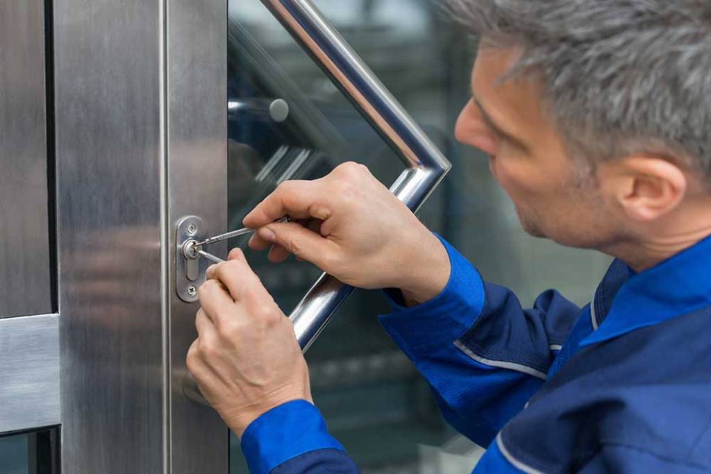 Male Lockpicker Fixing Door Handle At Home